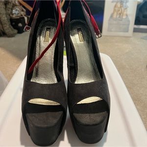 Suede platform peep toe pumps with ankle straps.